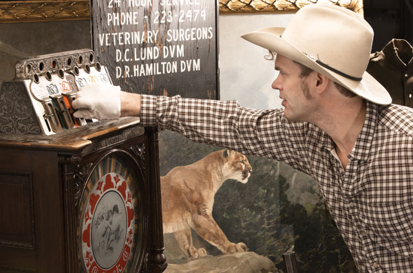 Corb Lund investigating one of the artefacts in the exhibition