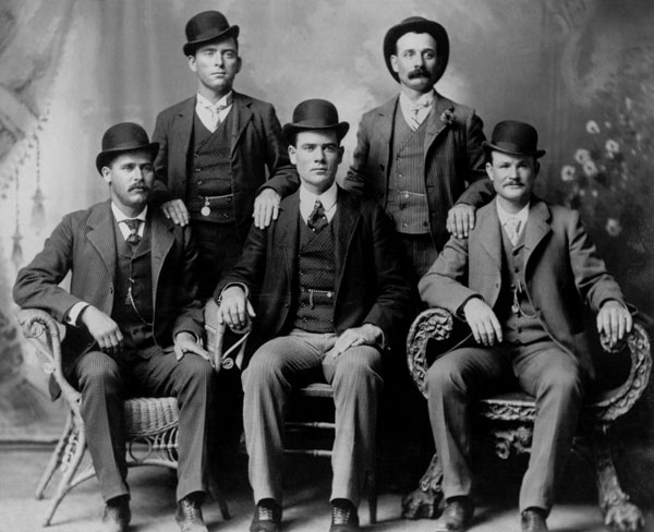 The Wild Bunch?Front row left to right: Harry A. Longabaugh, alias the Sundance Kid, Ben Kilpatrick, alias the Tall Texan, Robert Leroy Parker, alias Butch Cassidy. Standing, from left: Will Carver, Harvey Logan, alias Kid Curry. Fort Worth, Texas, 1900