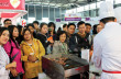 A crowd of buyers gathers around the CBI booth to watch how the chef prepares the grain-finished delicacy.