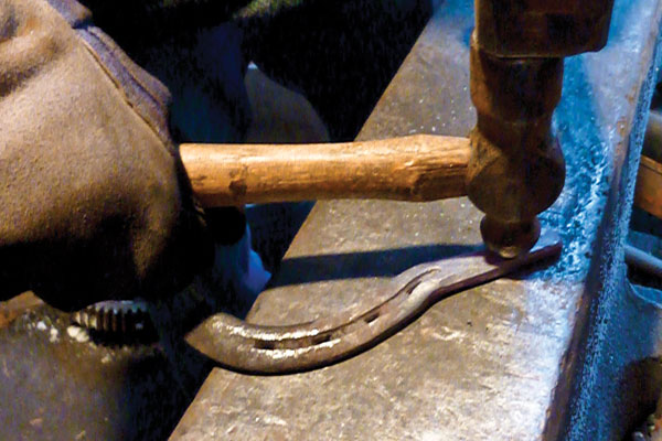Spread and round the jowls with the peen of a ball-peen hammer. You can dish the face slightly if you wish by holding the face over the far edge of the anvil and using hammer blows that miss the edge of the anvil.