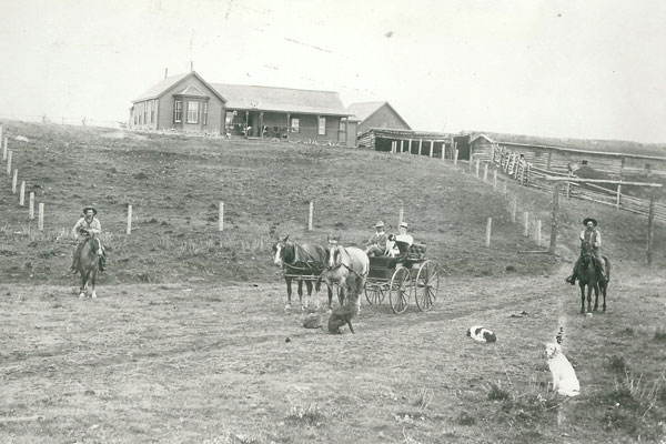 The XC Ranch; from left on horseback: ranch  foreman Ted Cook, John Fraser in the surrey; his wife  Muriel in the back seat; far right on horseback, John Bateman. Photo courtesy Daryl Drew.