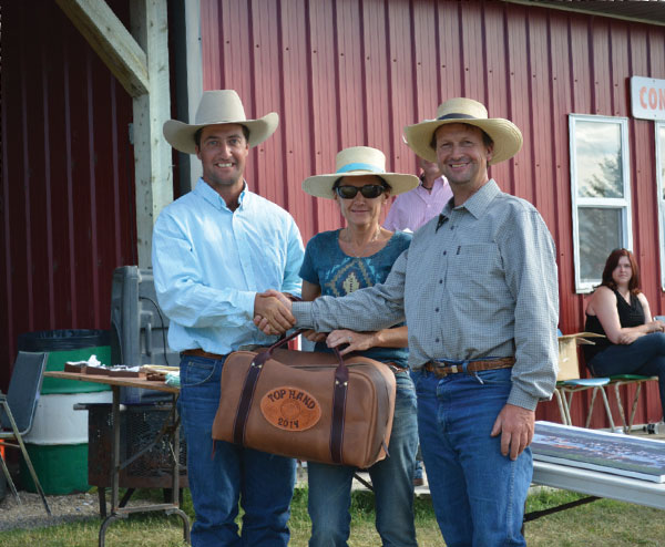 Top Hand Award went to Dan Chalifoux (left), accepting a custom gear bag made by Steve Mason, sponsored by Paula (centre) and Art Cox (right) of Somerset Tree Service.