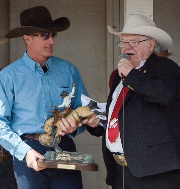 Jack Daines surprises 2002 World Champion Saddle Bronc rider, Glen O’Neill, with a replica of the bronze first won by O’Neill at the 1995 Calgary Stampede. Photo by Mike Copeman.