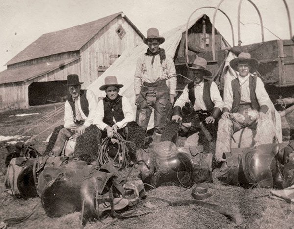 1906 was the first year Rod trailed cattle from the Rocking P to the John Ware ranch north of Brooks, which he had purchased from Ware’s estate. To make sure they had everything they needed, the men did a “Hudson’s Bay Start”—?amassing their saddles, bridles, blankets, bedrolls, tent, harness and repairs for the wagon, axes, shovel, stove and all the cooking things they needed like flour, sugar, salt, beans, bacon, pots and pans and camped out in the yard the night before they left for the two-week trail drive. Apparently this is what the Hudson’s Bay men did before they left on a venture so this is where the saying came from. From left: Dave Wheatcroft, Rod Macleay, Joe Case, Doc Mitchell and Chet Mitchell.